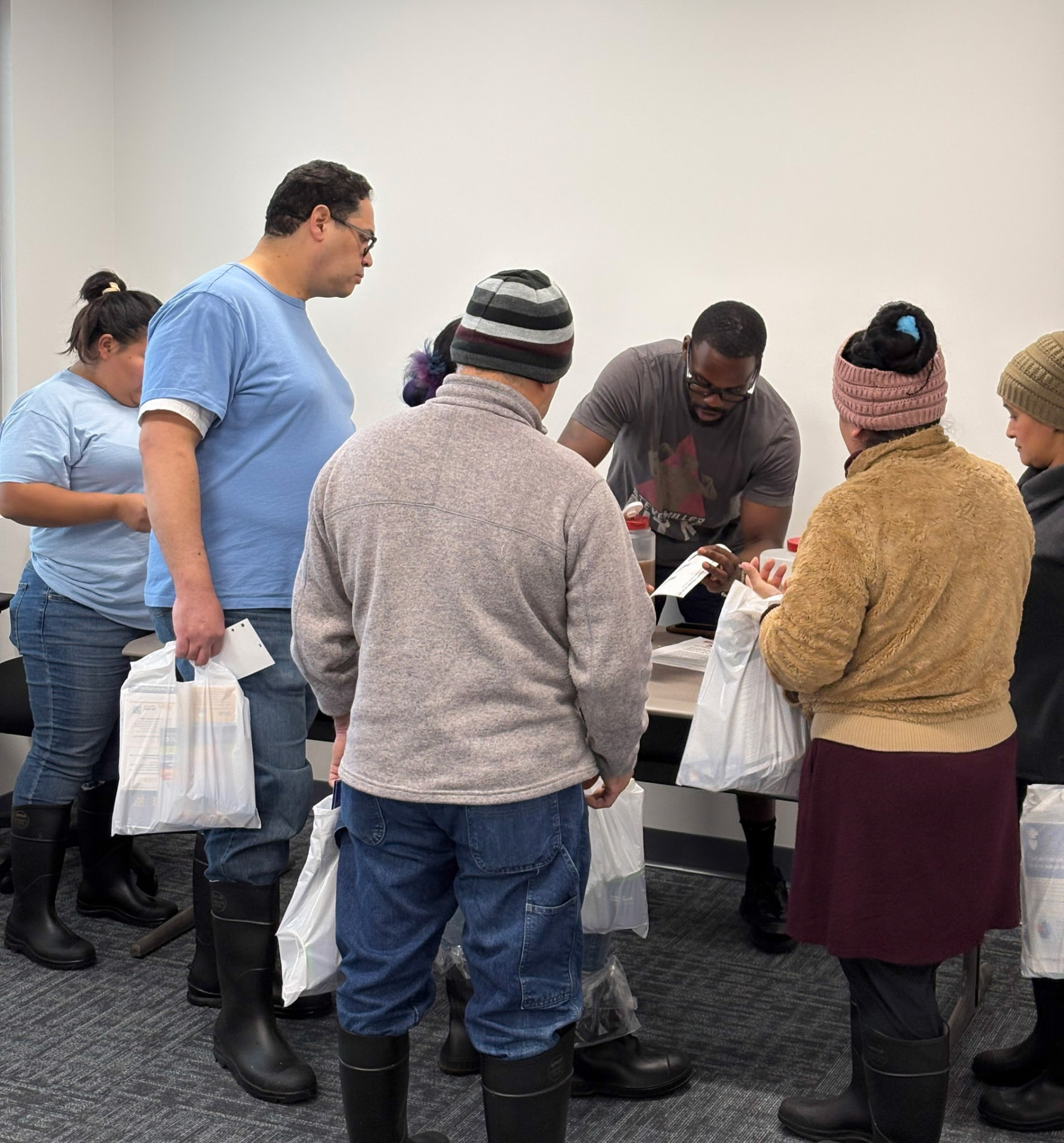 Community members receiving Signature Series samples at a wellness event