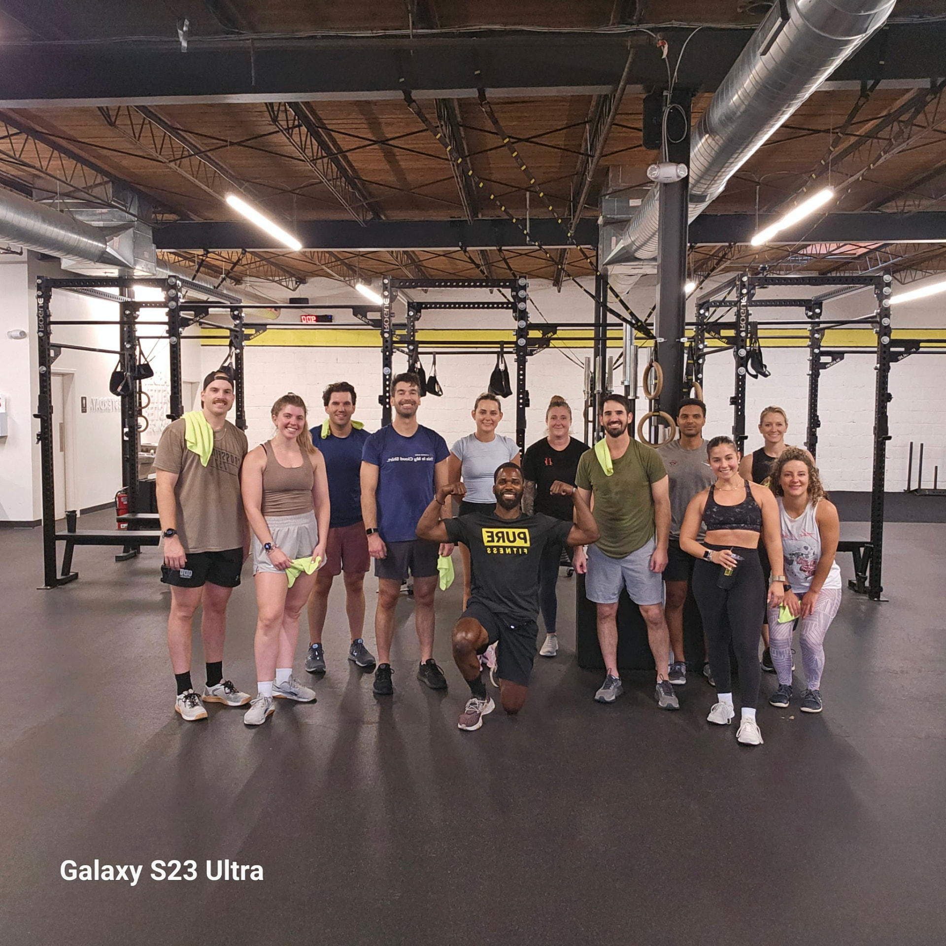 Steve Miller kneeling with a full PURE Fitness class after a training session